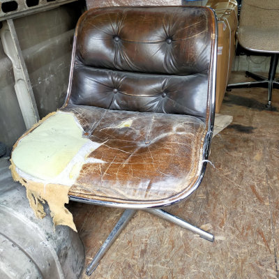 A destroyed Charles Pollock chair needs a leather upholsterer